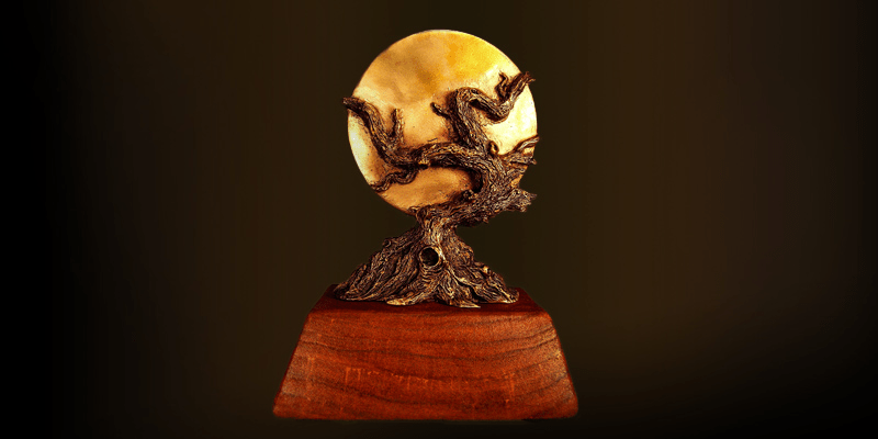 world fantasy award - a brown tree over a metal disk - on a black background